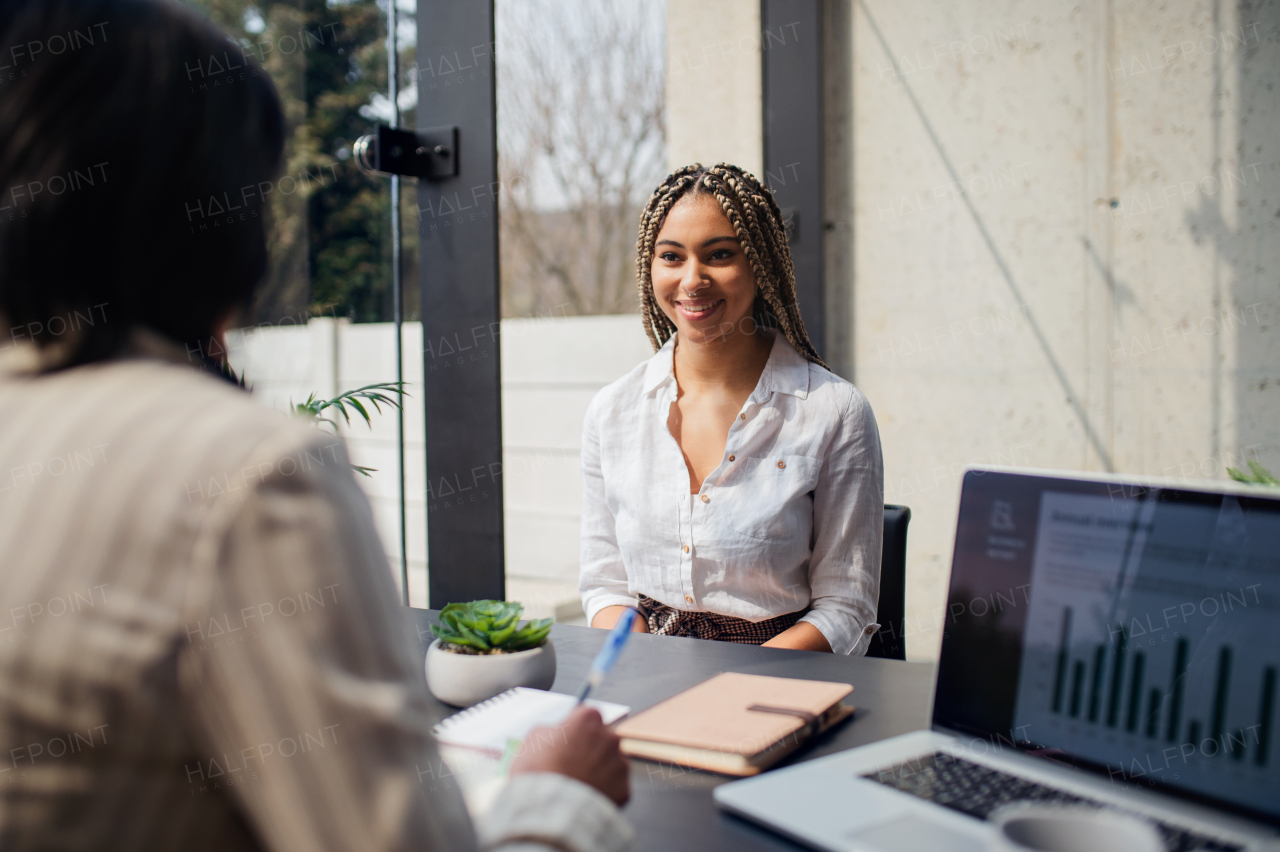 A happy young woman having job interview in office, business and career concept.