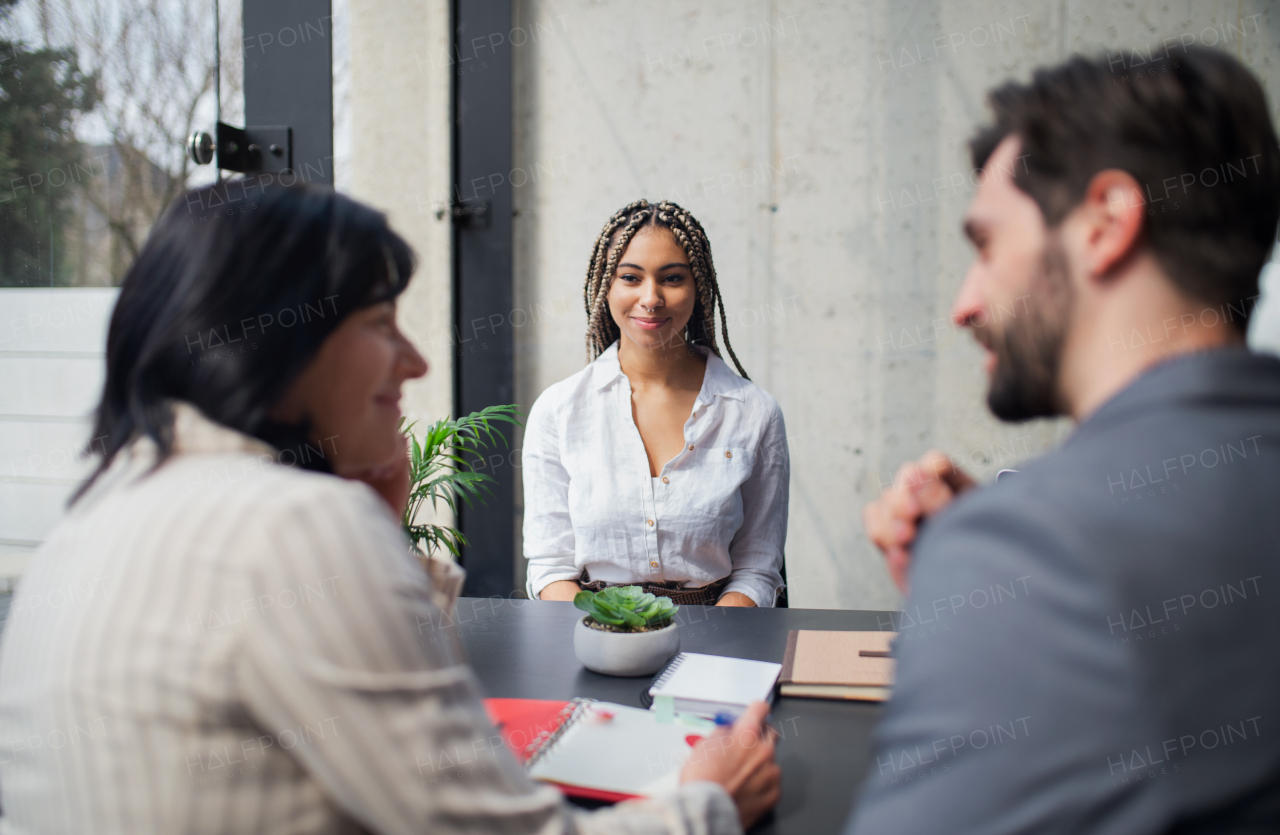 A happy young woman having job interview in office, business and career concept.