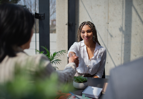 A happy young woman having job interview in office, business and career concept.