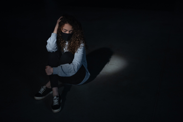 A top view portrait of depressed young woman indoors, covid-19 and mental health concept.