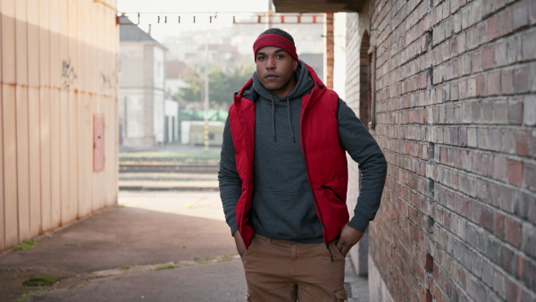 Portrait of young african american man in back street, serious.