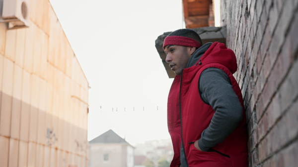 Two young men dealing drugs in the street, low angle view.