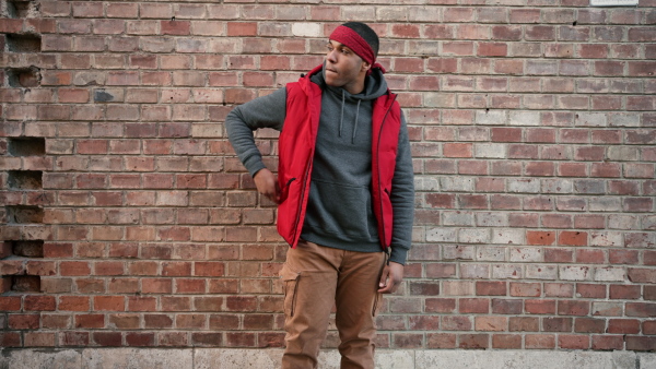 Portrait of young african american man with a gun. Camera raid. Detail at gun.