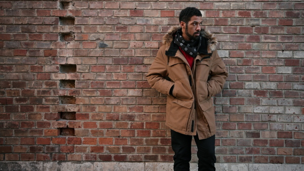 Portrait of young african american man with a gun. Camera raid. Detail at gun.