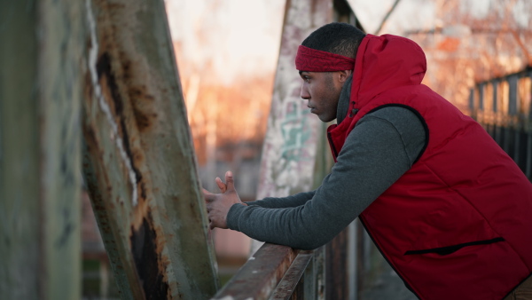 Two young black friendstanding on old bridge.