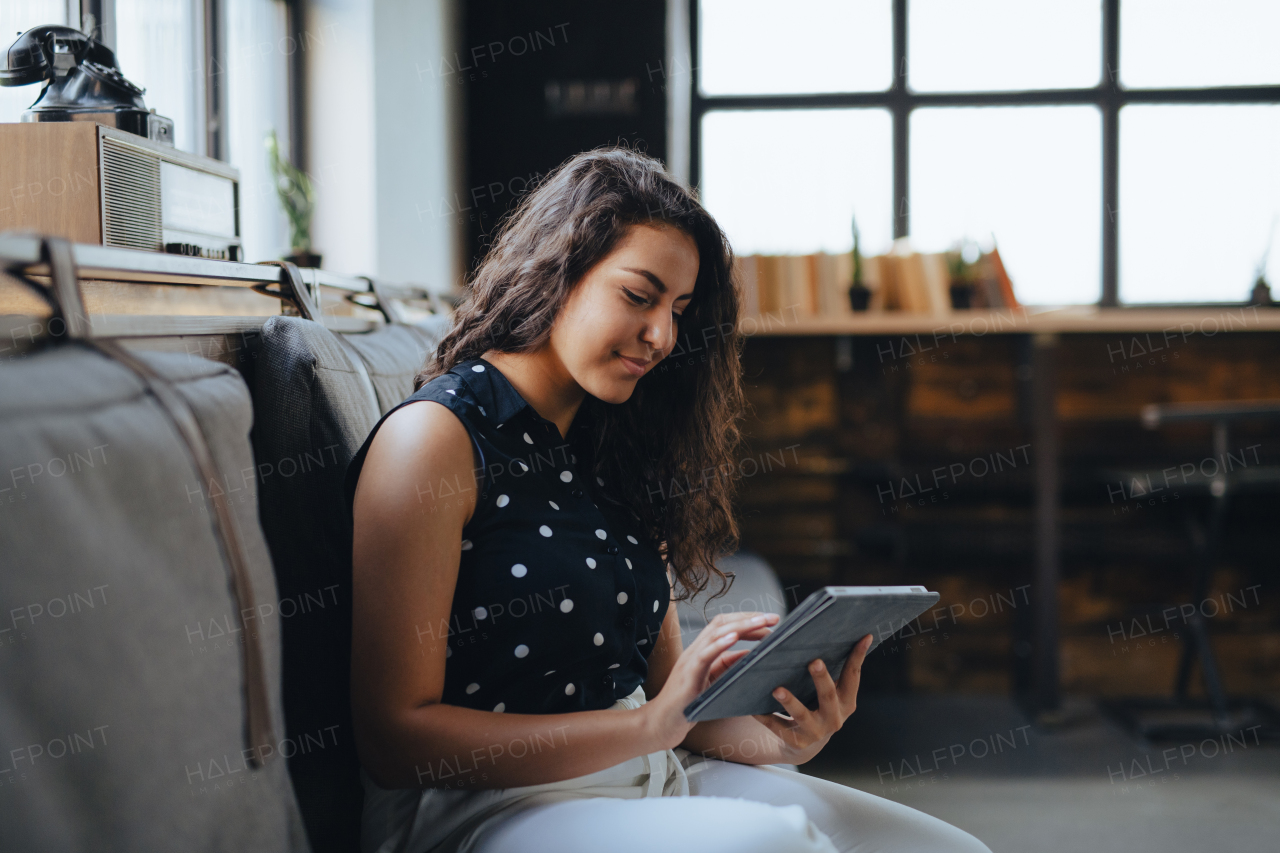 Universtiy student studying in coffee shop, prepraing for final exams at the end of semester. Businesswoman preparing for meeting, working on presentation on tablet, sitting in modern office.