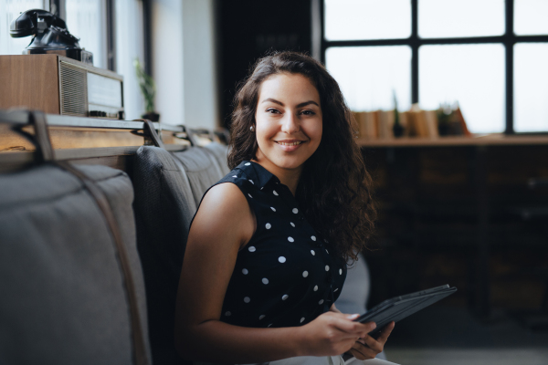 Universtiy student studying in coffee shop, prepraing for final exams at the end of semester. Businesswoman preparing for meeting, working on presentation on tablet, sitting in modern office.