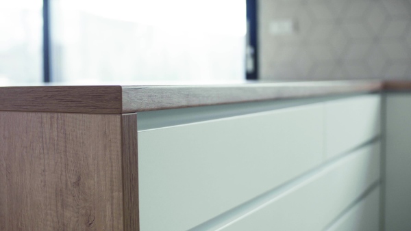 A close-up view of modern kitchen cupboards in house or flat in new home. A moving in new home concept.