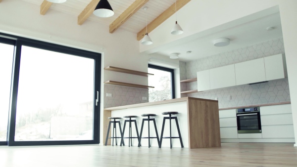 A modern interior of an open space kitchen in house or flat in new home. A moving in new home concept.