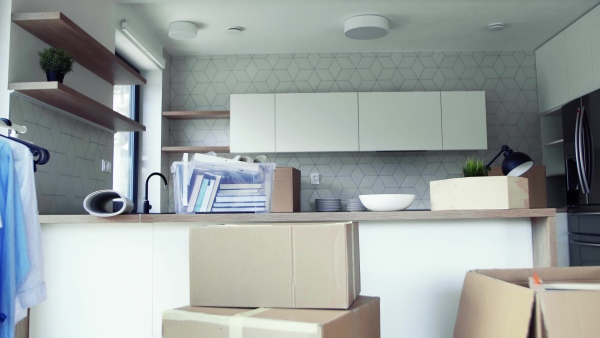 Moving boxes and clothes rack on the floor in new home. A moving in new home concept.