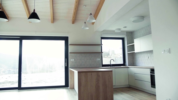 A modern interior of kitchen in a house or flat in new home. A moving in new home concept. Slow motion.