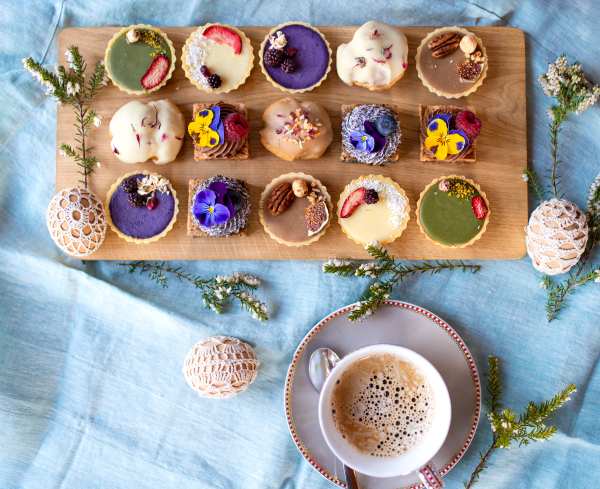 A top view of cup of coffee and dessert on table, close-up.