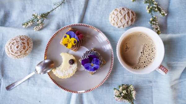 Top view of cup of coffee and dessert on table, a close-up.