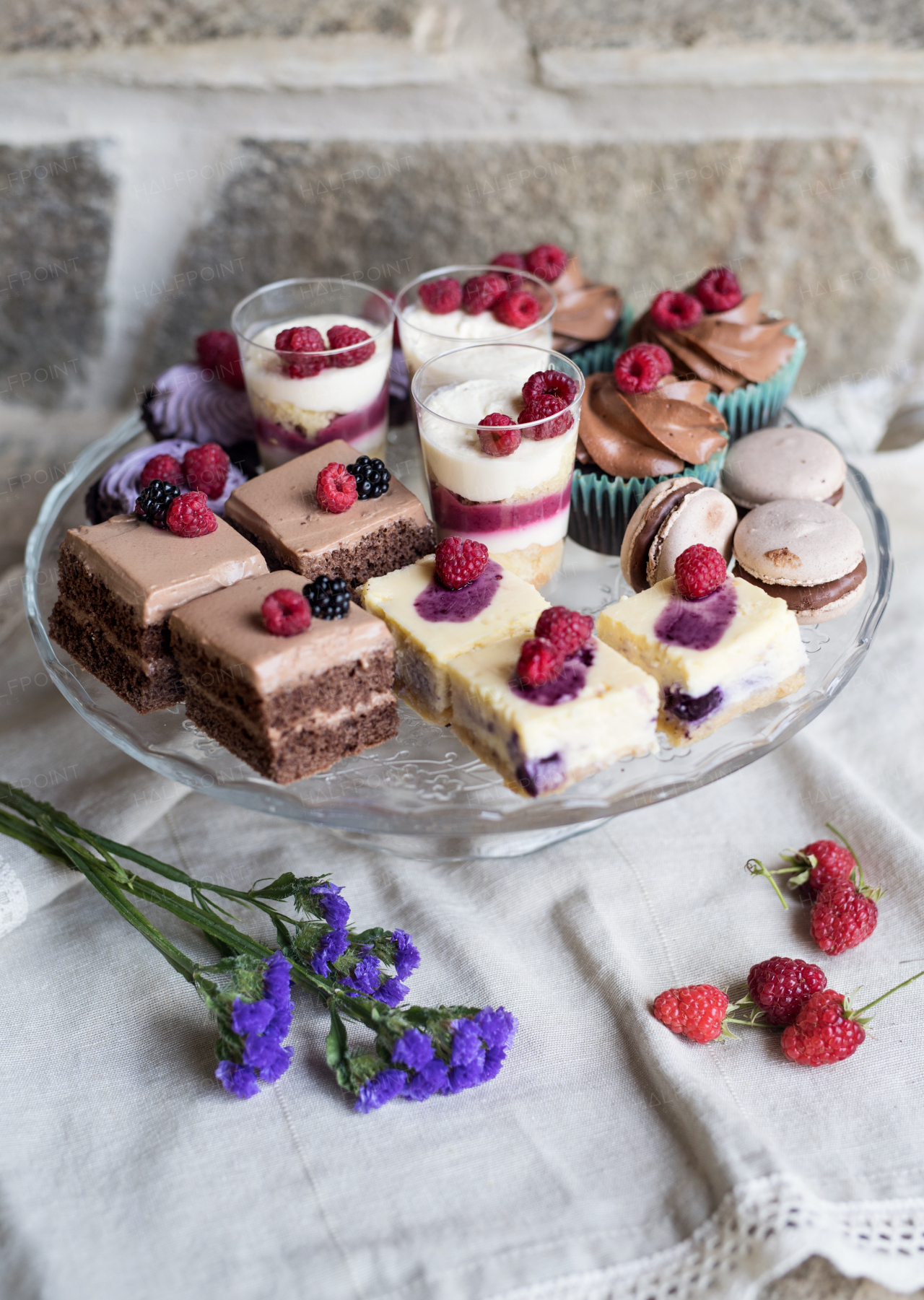 A selection of colorful and delicious cake desserts on tray on table.