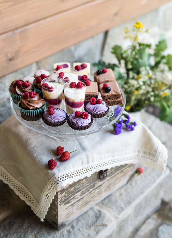 A selection of colorful and delicious cake desserts on tray.