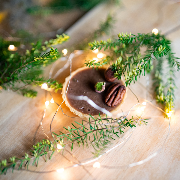 Top view of delicious cake dessert on rusty wooden table, lights chain decoration.