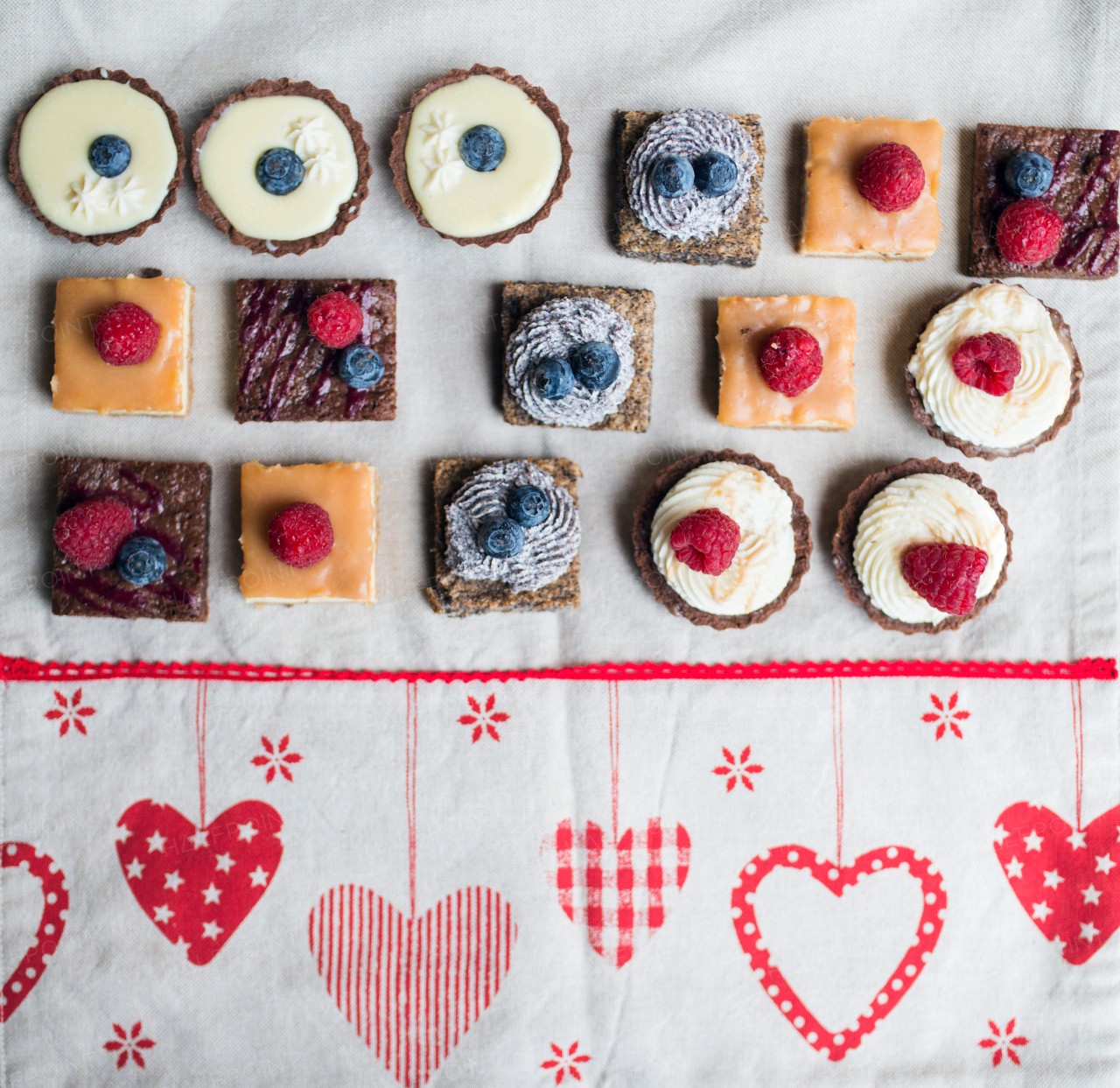 A top view of selection of colorful and delicious cake desserts on table.