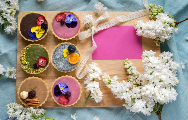 A top view of selection of colorful and delicious cake desserts in box on table. Copy space.