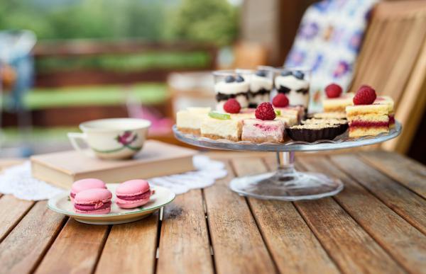 A cup of coffee and desserts on table, close-up.