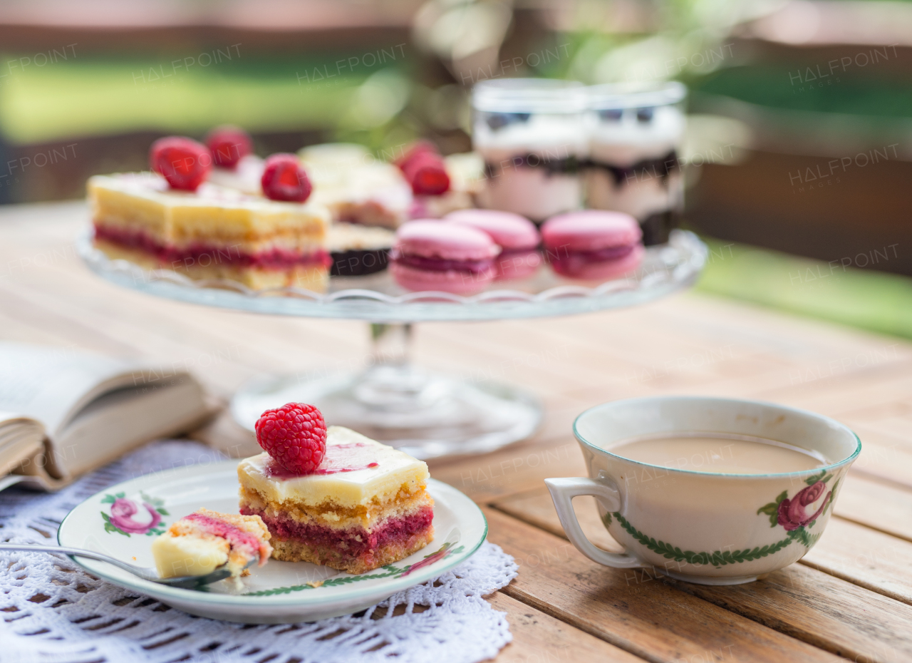 A cup of coffee and desserts on table, close-up.