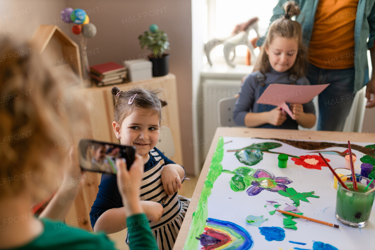 A group of little kids working on project during creative art and craft class at school.