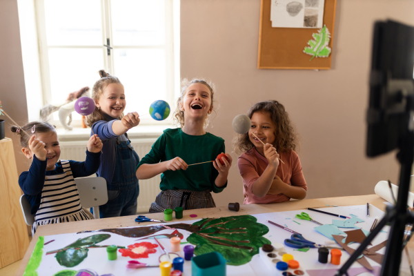 Little kids working on project during a creative art and craft class at school.