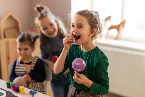 A group of little kids having fun during creative art and craft class at school.