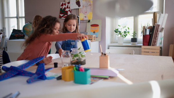 Happy little children preparing for an art and craft class indoors at school