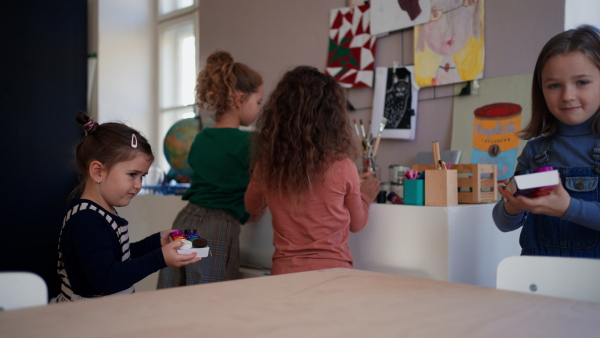 Happy little children preparing for an art and craft class indoors at school