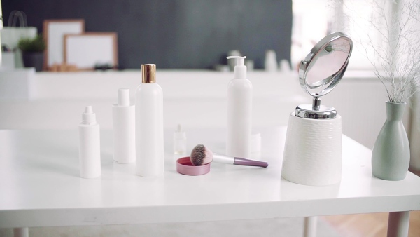 A mirror and beauty products on the desk. Slow motion.