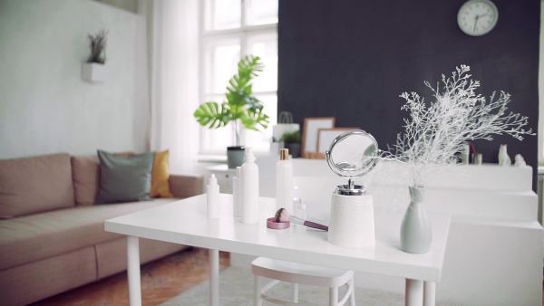 A mirror and beauty products on the desk. Slow motion.