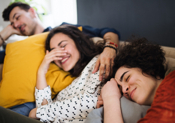 A group of young cheerful friends indoors at home, having fun. House sharing concept.