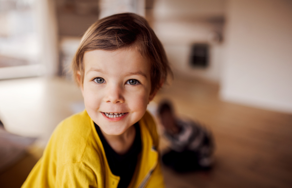 A happy cute small girl playing at home. Copy space.