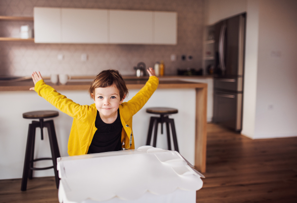 A happy cute small girl playing at home. Copy space.