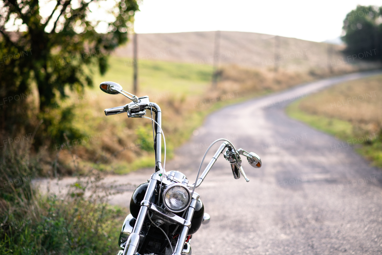 A front view of part of motorbike on road in countryside. Copy space.