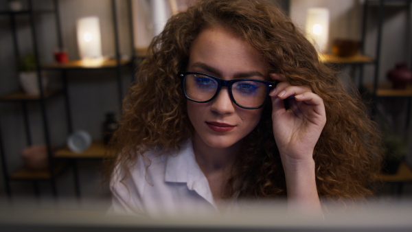 Close up of young woman working on computer in an office.