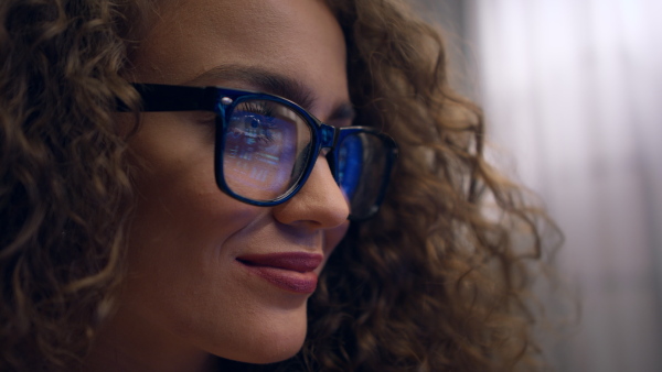 Close up of young woman working on computer in an office.