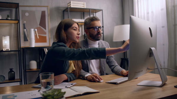 Two collegues working in office together, consulting.