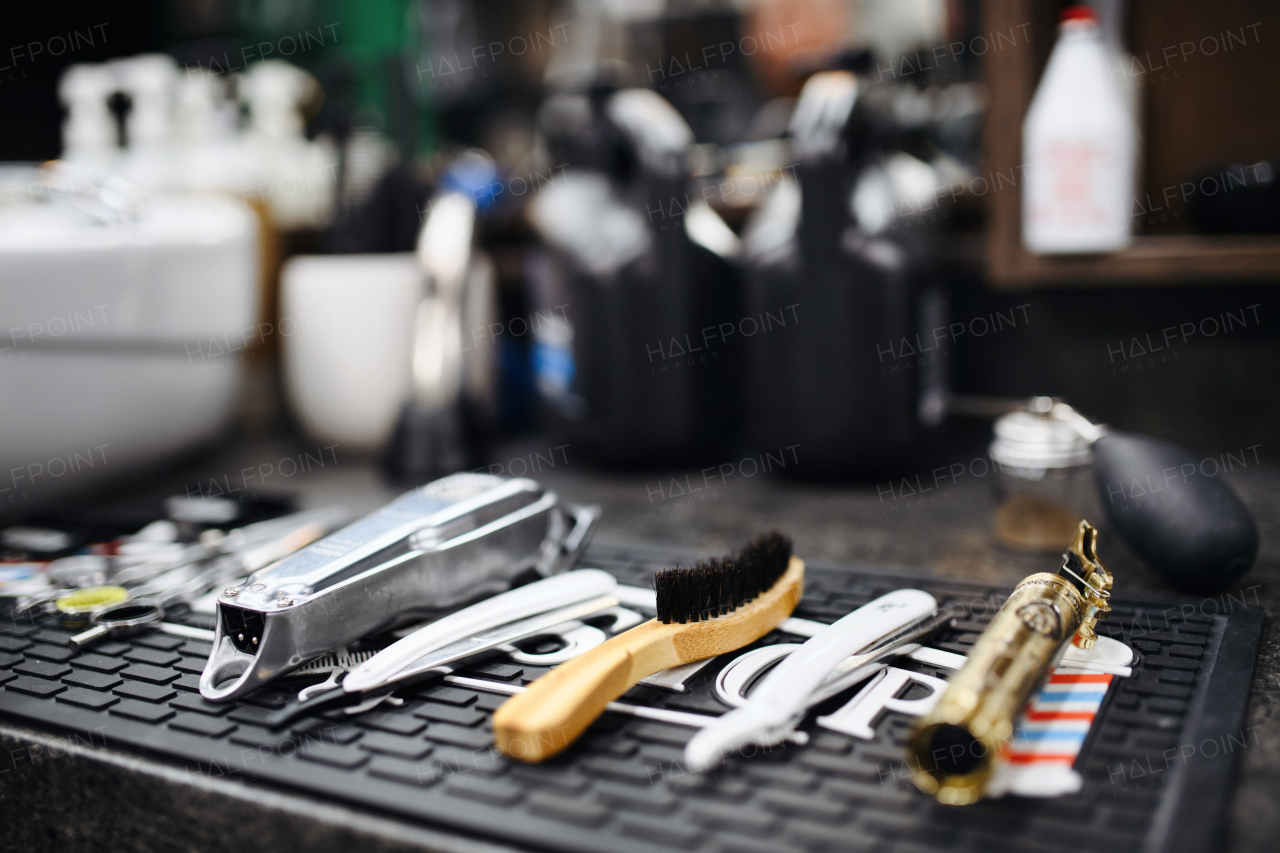 Shaving accessories and tools in barber shop, focus on foreground.