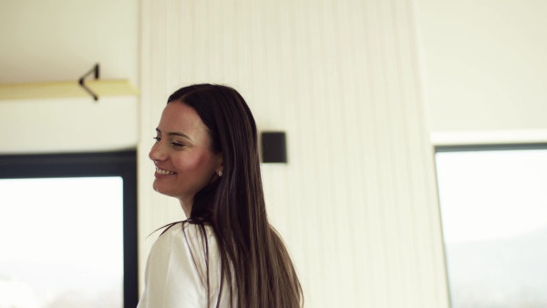 An excited young woman in new home, spinning. A moving in new home concept.