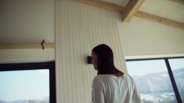 An excited young woman in new home, spinning. A moving in new home concept. Slow motion.