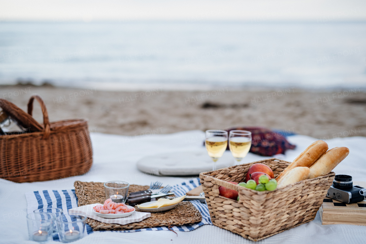 A beach picnic with schripms, beer, candles.