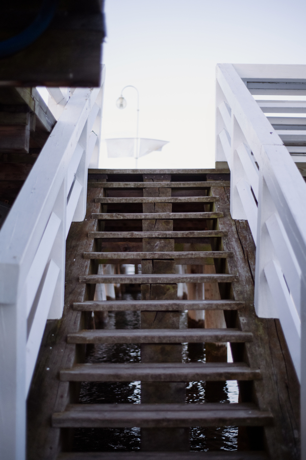 Wooden stairs leading to a pier by sea