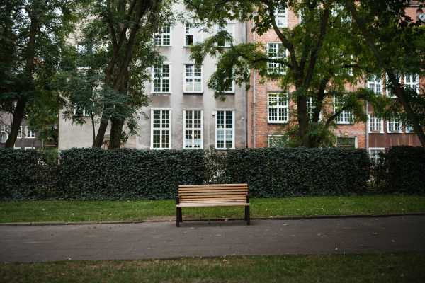 A wooden empty bench in hisotric town park.