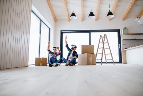 A mature man and his senior father with VR goggles furnishing new house, a new home concept.