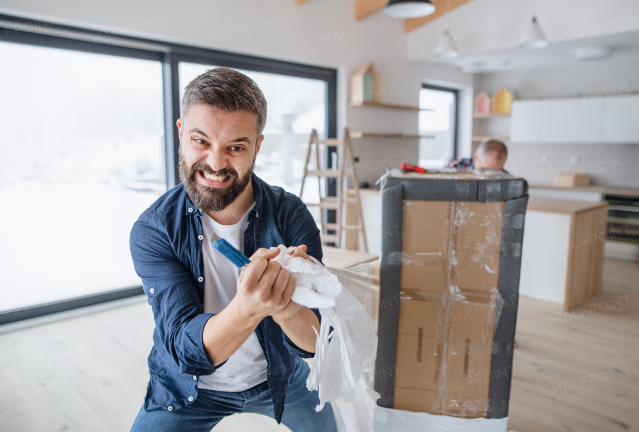 A portrait of mature man with his senior father furnishing new house, a new home concept. Copy space.