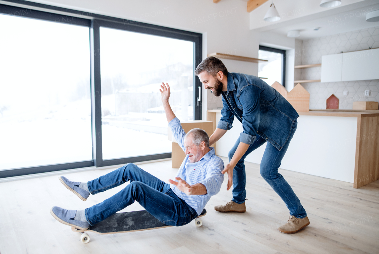 Two cheerful men having fun when furnishing new house, a new home concept.