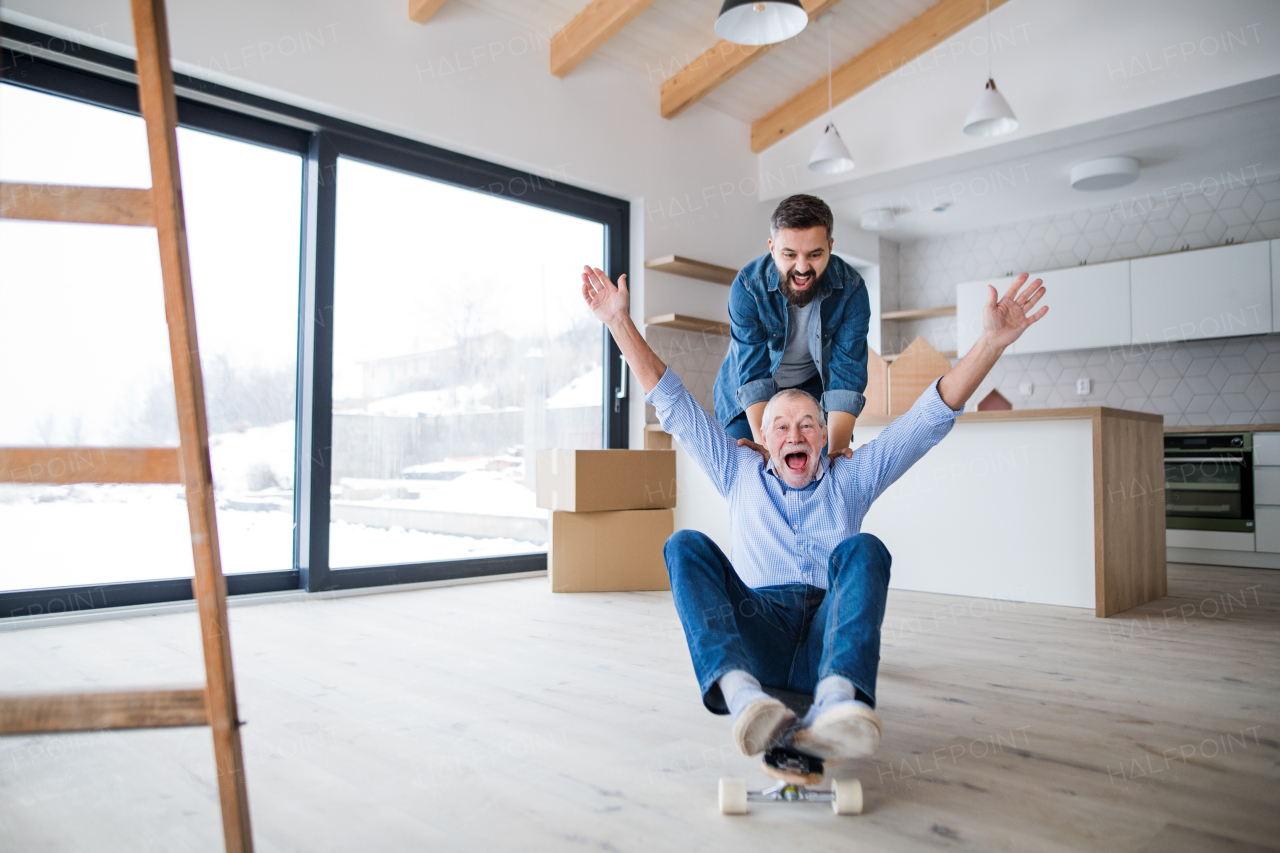 Two cheerful men having fun when furnishing new house, a new home concept.