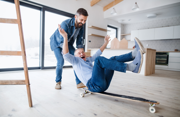 Two cheerful men having fun when furnishing new house, a new home concept.