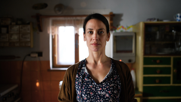 Portrait of sad poor mature woman indoors at home, poverty concept.